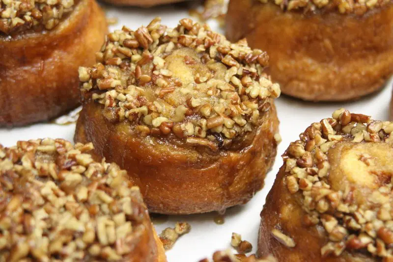 A close up of some donuts with nuts on top