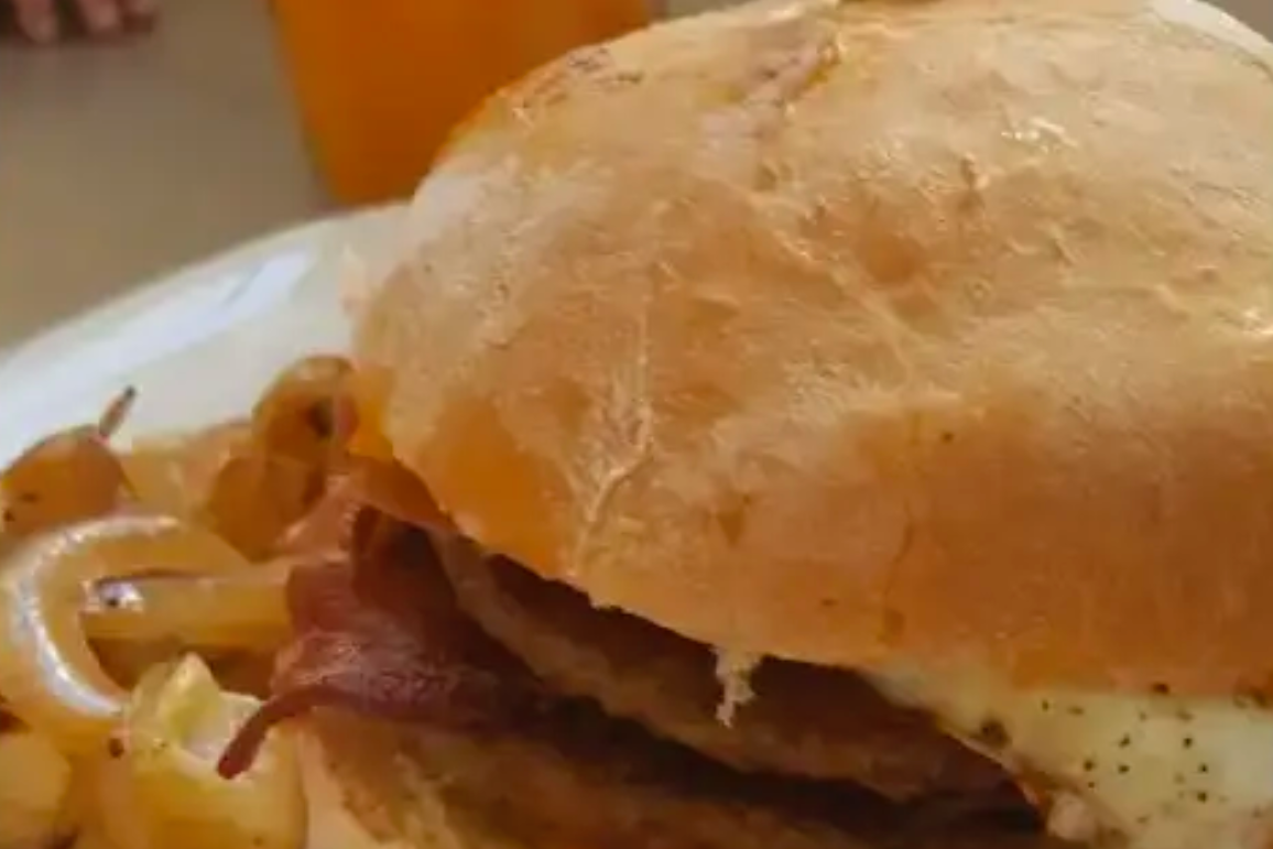 A close up of a sandwich with bacon