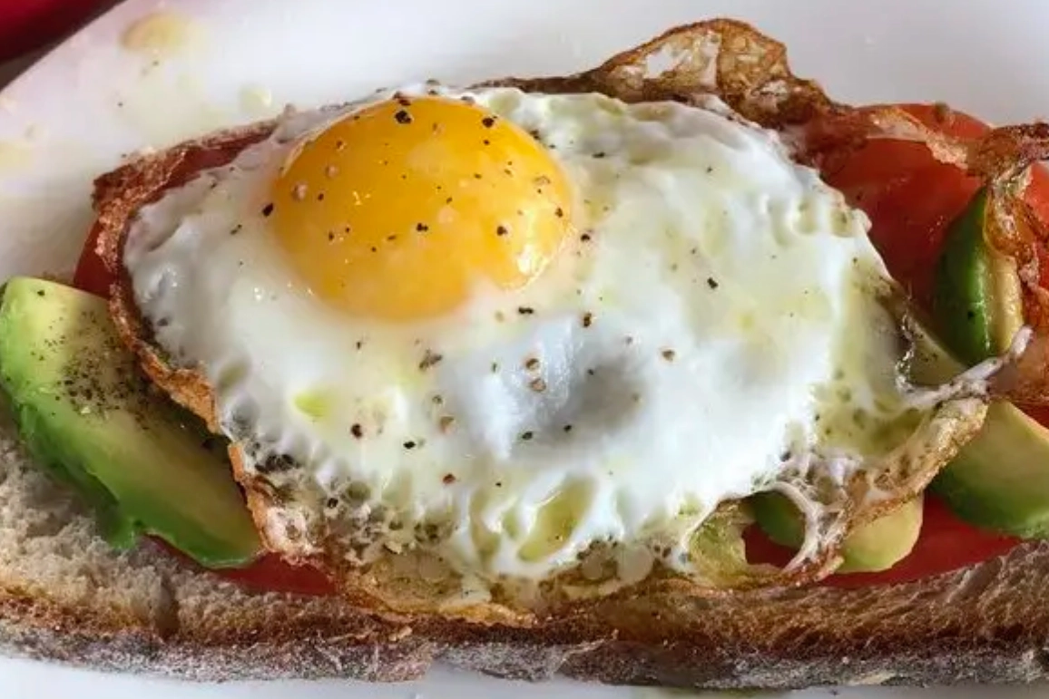 A piece of bread with an egg on top.